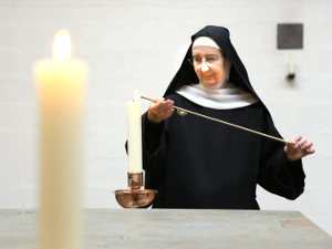 Sister lighting altar candles